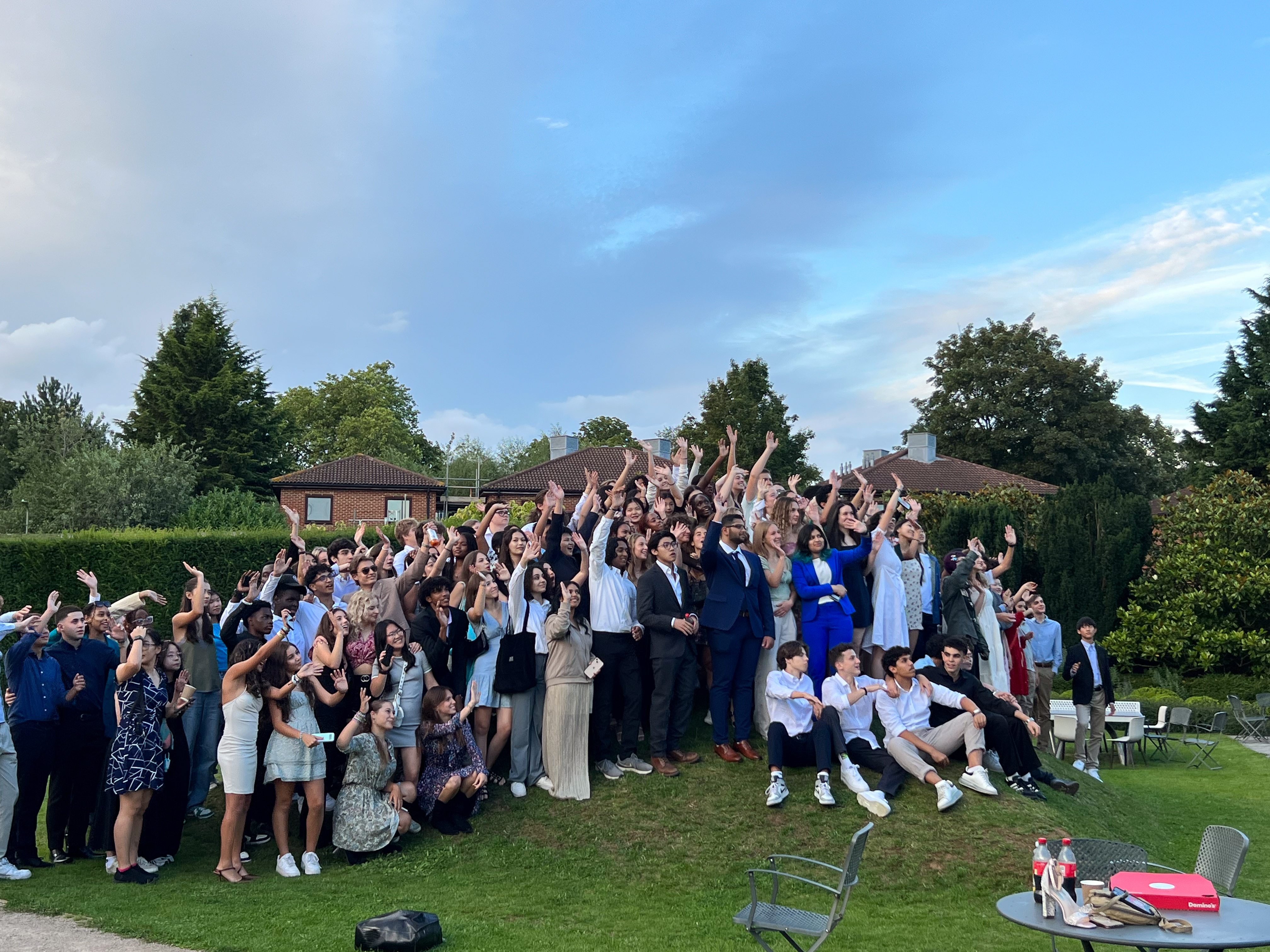 group shot of students waving